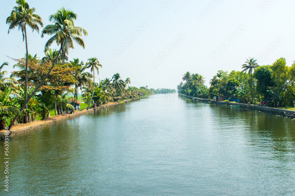 Showing beautiful backwater and houseboat of alleppey or Alappuzha from House boat. Boat moving through the waves to the destination. 