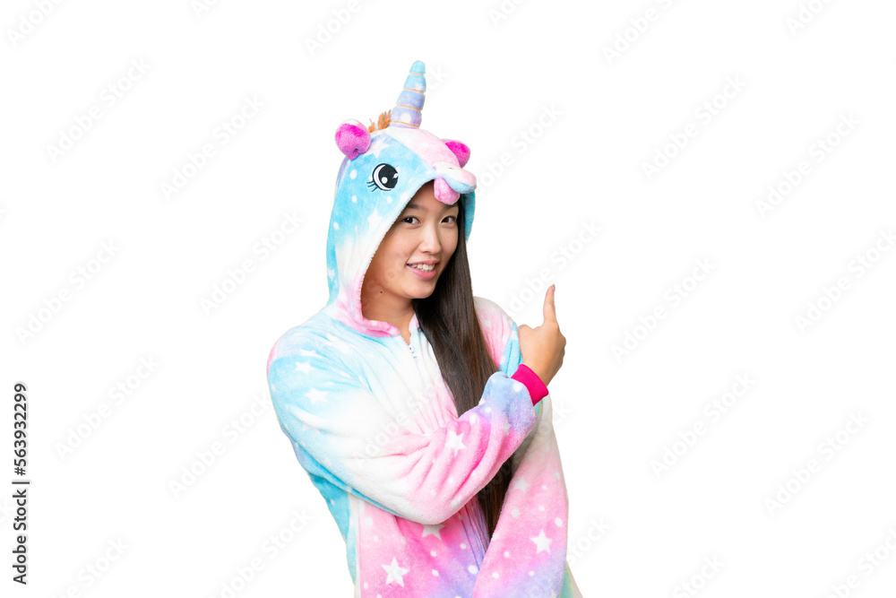 Young Asian woman with unicorn pajamas over isolated chroma key background pointing back Young Asian woman with unicorn pajamas over isolated chroma key background pointing back