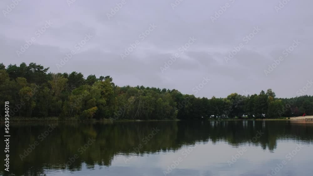 Natural landscape of the lake, high definition, the movement of waves against the background of the autumn forest. The reflection of clouds on the ripples of water. Germany. Natural landscape of the lake, high definition, the movement of waves against the background of the autumn forest. The reflection of clouds on the ripples of water. Germany.
