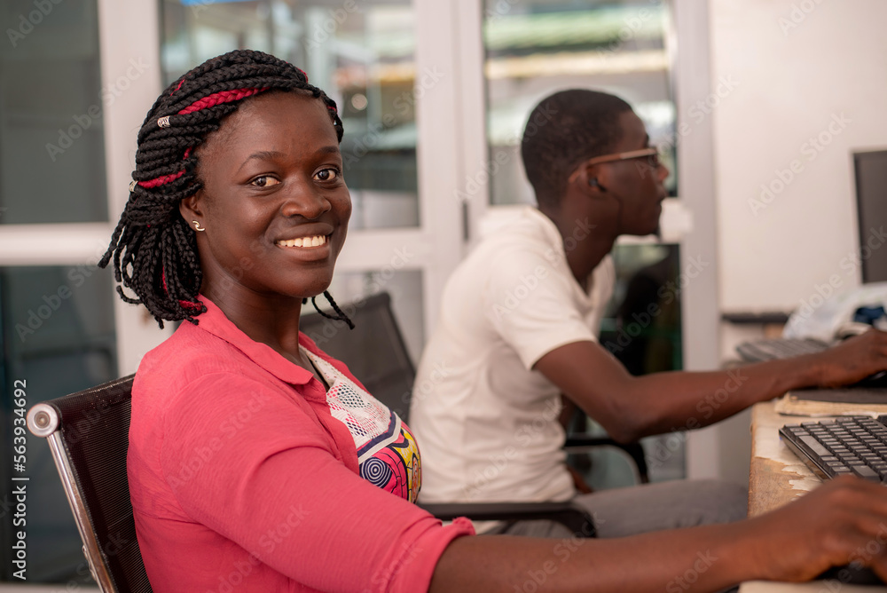 close-up of a businesswoman working on computer, smiling. close-up of a businesswoman working on computer, smiling.