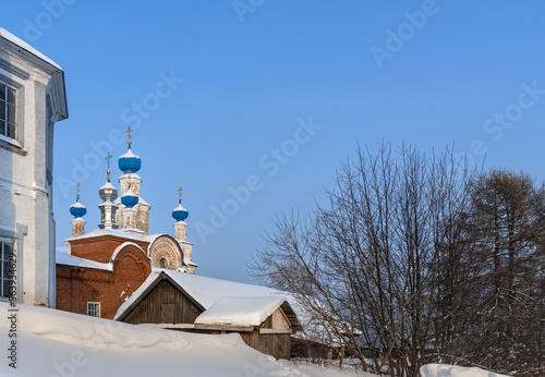 View of an ancient church with blue domes on a hill in Cherdyn (Northern Urals, Russia) in winter.