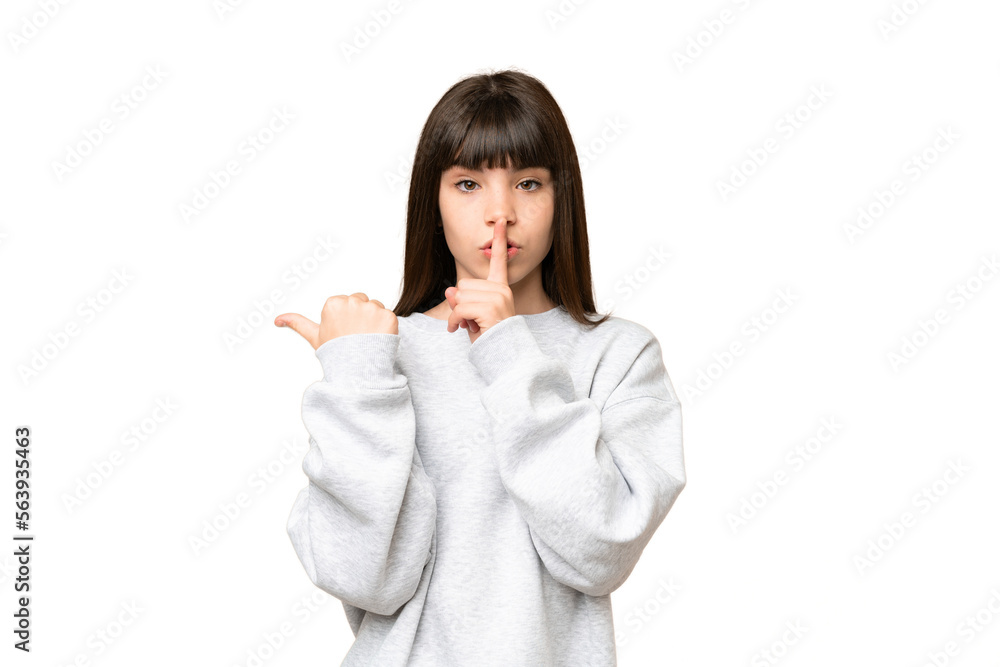 Little girl over isolated green chroma key background pointing to the side and doing silence gesture Little girl over isolated green chroma key background pointing to the side and doing silence gesture