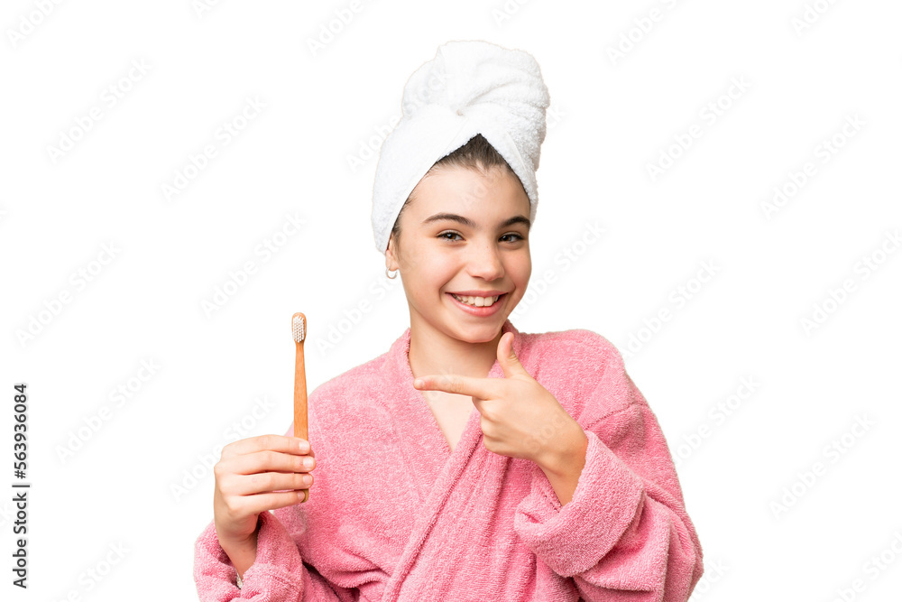 Little girl brushing teeth over isolated chroma key background and pointing it Little girl brushing teeth over isolated chroma key background and pointing it