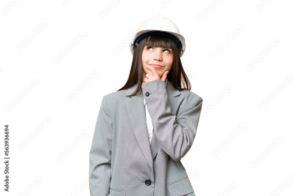 Little girl playing as a architect with helmet and holding blueprints over isolated background having doubts Little girl playing as a architect with helmet and holding blueprints over isolated background having doubts