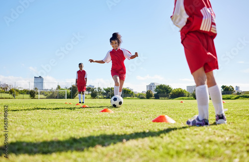 Fototapeta Naklejka Na Ścianę i Meble -  Soccer, training or running and a girl team playing with a ball together on a field for practice. Fitness, football and grass with sports kids dribbling on a pitch for competition or exercise