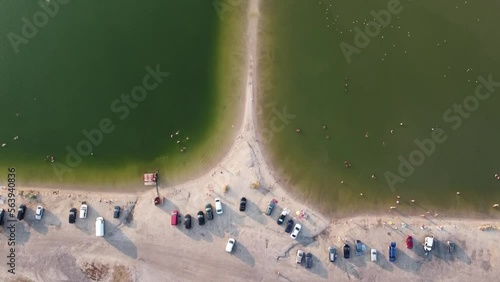 Camping on the lake. People are resting and swimming. Two lakes are separated by a coastline. High quality FullHD footage