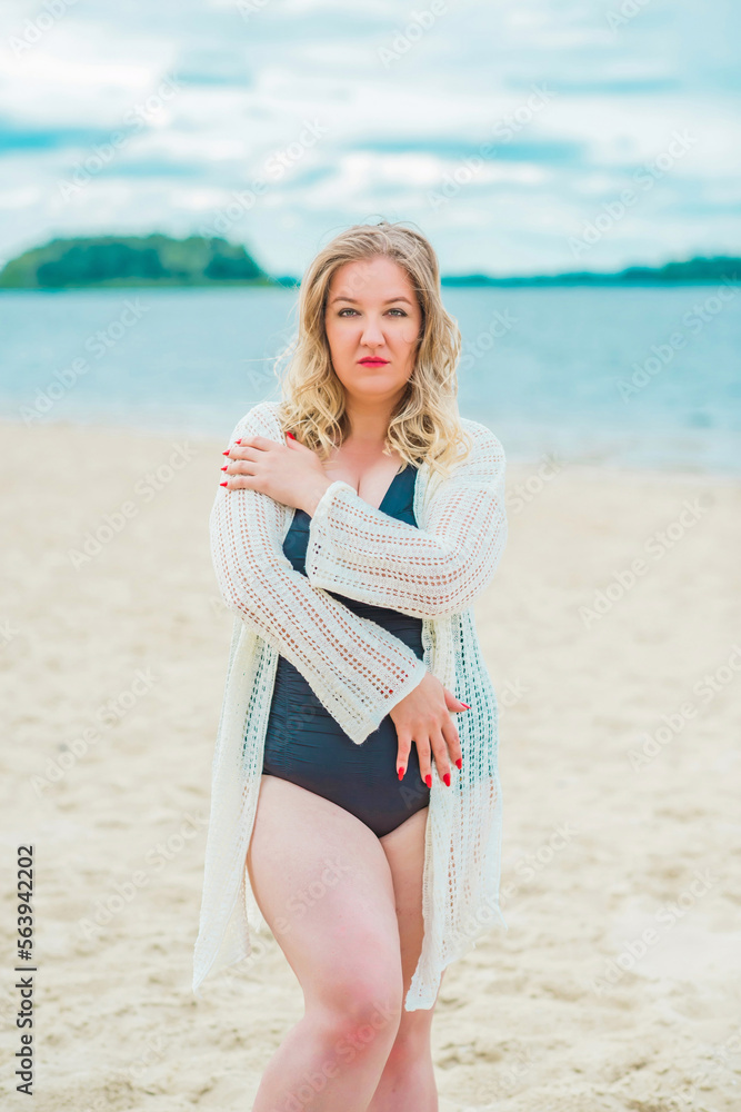 Plus size European blonde woman in stylish romantic women's summer clothes at beach. Concept of sizes, happy nice natural beautiful lady Plus size European blonde woman in stylish romantic women's summer clothes at beach. Concept of sizes, happy nice natural beautiful lady