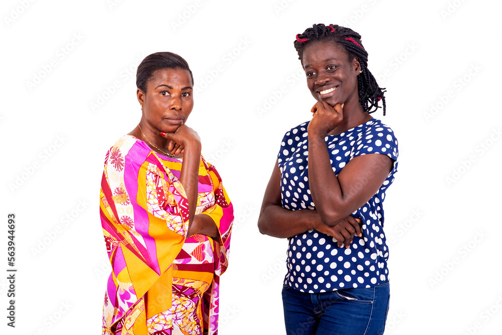two beautiful women holding each one with crossed arm and raised hand on chin. two beautiful women holding each one with crossed arm and raised hand on chin.