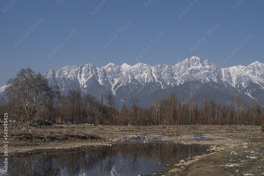 snow covered mountains by a river, Kashmir snow covered mountains by a river, Kashmir