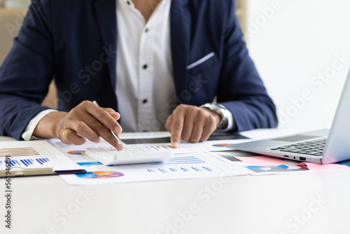 Accountant working financial investment on calculator, calculate, analyze business and marketing growth on financial document data graph, Accounting, Economic, budget planning.