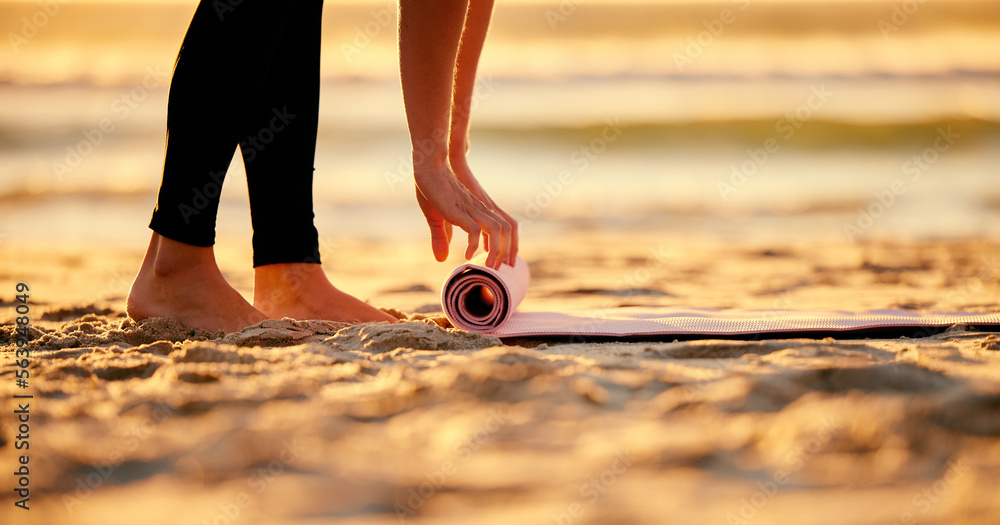 Beach, hands and woman roll yoga mat getting ready for workout, exercise or stretching. Zen, meditation and feet of female yogi outdoors on seashore while start chakra training and pilates. - obrazy, fototapety, plakaty 