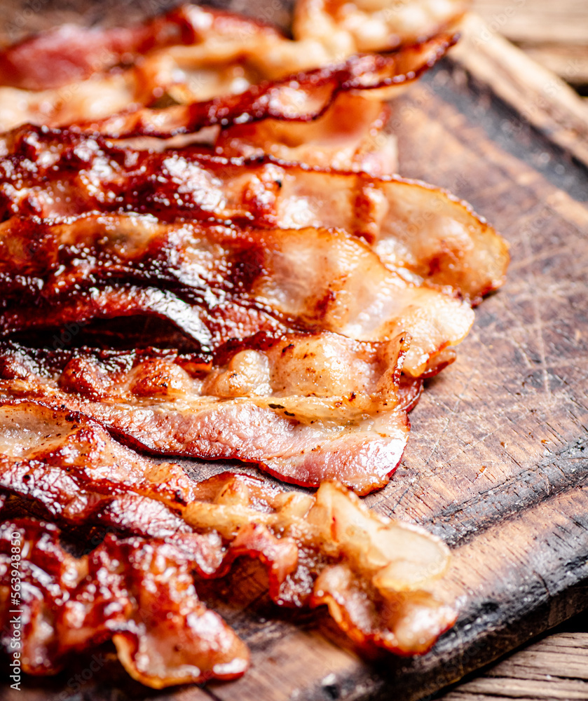 Fried bacon on a cutting board. 