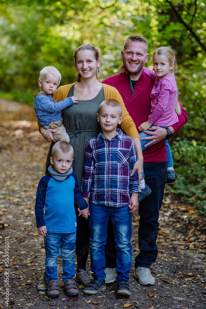 Portrait of big happy family with kids in a forest.