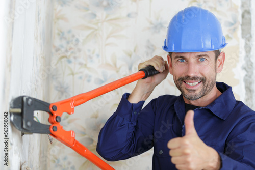 Obraz na plátně male builder using bolt cropper with thumbs-up
