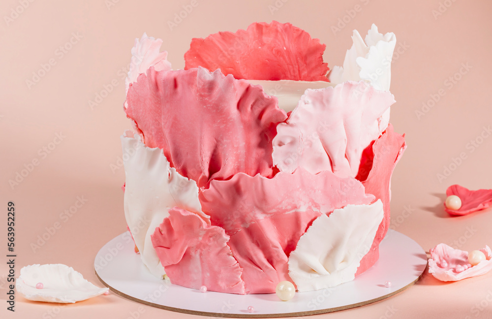 Cake for birthday with pink element made from pastry mastic on pink beige background,beautiful decor Cake for birthday with pink element made from pastry mastic on pink beige background,beautiful decor