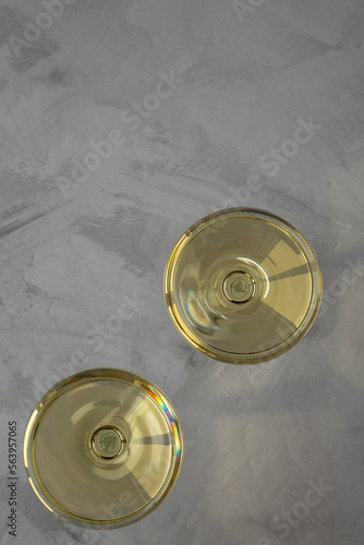 Sparkling Champagne in a Coupe Glass on a gray background, top view. Flat lay, overhead, from above. Copy space.