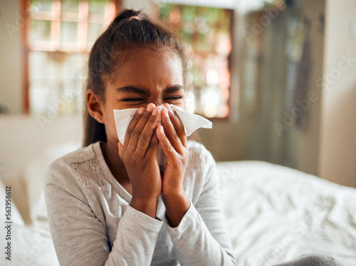 Health, covid and sick black girl blowing nose in home bedroom. Wellness, healthcare and kid with tissue to wipe for virus, infection or cold, flu or fever, allergy or corona illness in house alone.