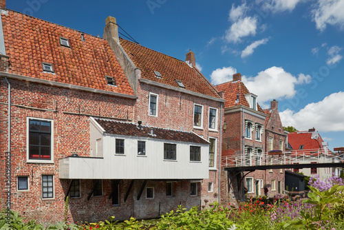 Summer view of Dutch medieval houses with hanging kitches at the Damsterdiep canal in Appingedam, Groningen, The Netherlands