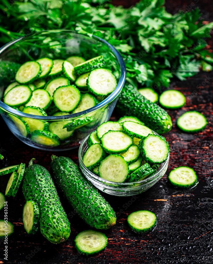 Sliced and whole cucumbers on the table. Sliced and whole cucumbers on the table.