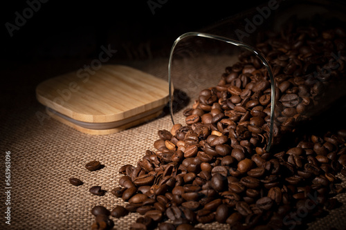 Coffee beans spilled out of the jar onto the table in the kitchen 