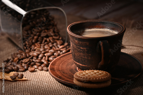 Cup of coffee and coffee beans on the table in the kitchen 