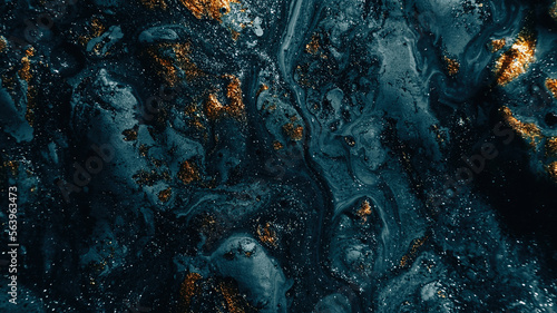 Sparkling fluid. Abstract background. Ink mix. Defocused shiny blue silver golden color glitter particles texture paint wave dark abstract background.