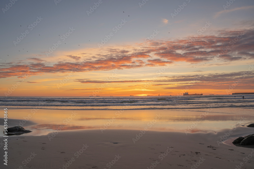 Sunset on the beach with peace of orange colors and blue sea