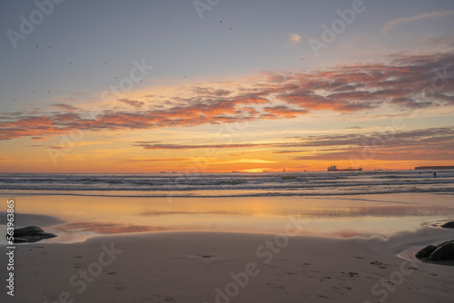 Sunset on the beach with peace of orange colors and blue sea