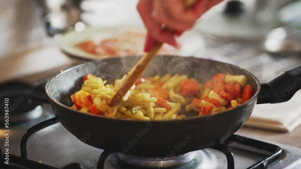 Zucchini with carrots and onions frying in pan. Zucchini with carrots and onions frying in pan.