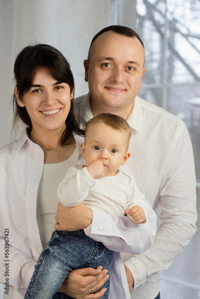 Portrait of young parents with a small child Portrait of young parents with a small child