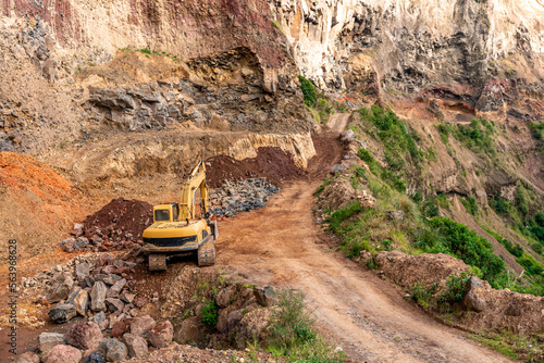 excavator at a quarry in the mountains