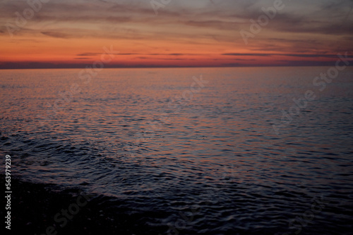 red sunrise over calm blue sea