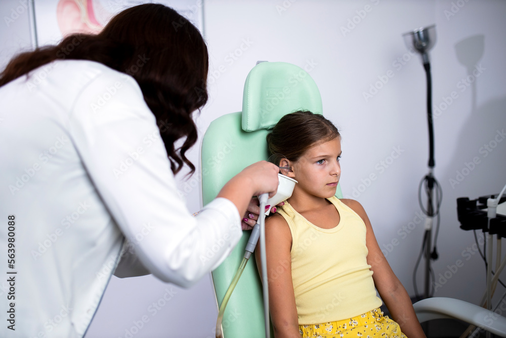 A woman doctor examines the ears of a patient in the ORL clinic. A woman doctor examines the ears of a patient in the ORL clinic.