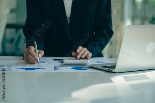 Business woman accountant, office worker working on desk, hand pressing calculator to calculate business profit and loss, calculating budget, income. Expense of credit card for payment on table.