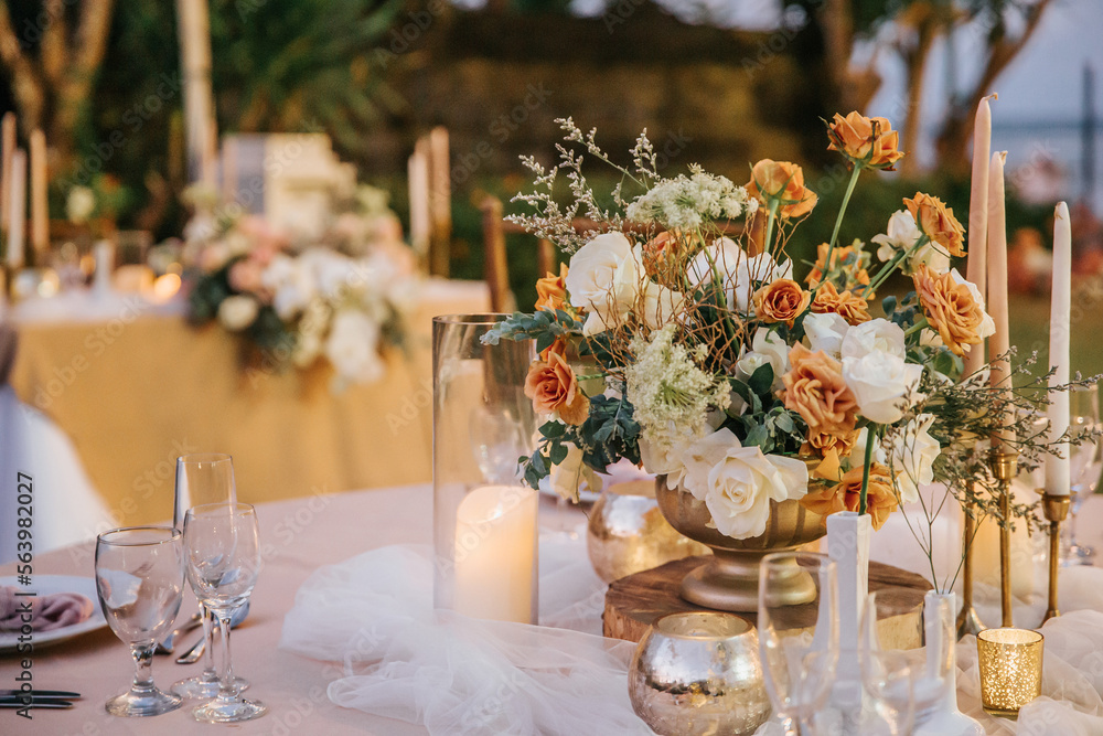 Beautiful table setting with tableware, flowers, candles, accessories and rose centerpiece for a party, wedding reception, gala banquet or other holiday event. - obrazy, fototapety, plakaty 