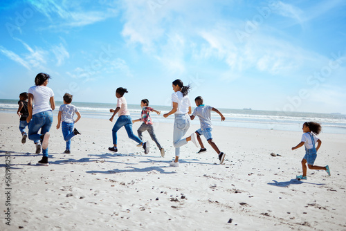 Running family, beach and adoption kids with happiness, bonding and sand with speed on summer vacation. Women, children and happy workout for group on holiday by ocean with diversity, love and care