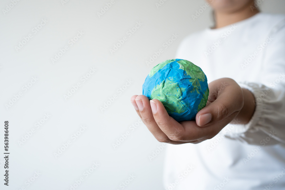 Hands holding earth paper and water paint. Concept of protecting the world from global warming Hands holding earth paper and water paint. Concept of protecting the world from global warming