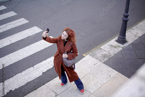 woman taking a selfie in the street © DondykRiga