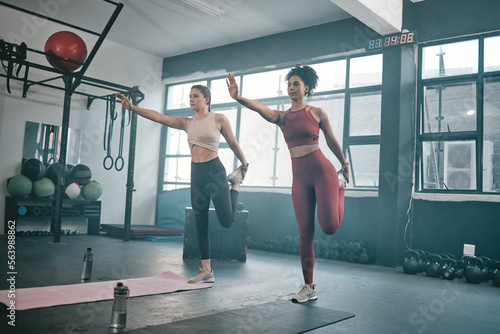 Balance, stretching and friends with women in gym for training, workout and exercise. Teamwork, health and personal trainer with girl and muscle warm up for wellness, sports and fitness goals
