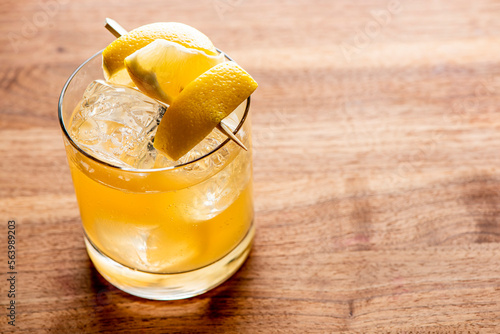 Whiskey sour. Classic Cocktail. Mixed drink with whiskey, lemon juice, sugar, and optionally, a dash of egg white. It is a type of sour, a mixed drink with base spirit, citrus juice, and a sweetener.  photo