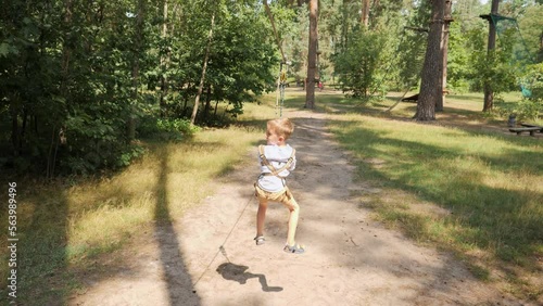 Wallpaper Mural Happy cheerful boy riding down the zip-line rope at outdoor adventure park. Active childhood, healthy lifestyle, kids playing outdoors, children in nature Torontodigital.ca