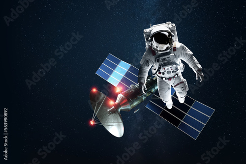Fototapeta Naklejka Na Ścianę i Meble -  Astronaut in a white spacesuit in space on the background of a satellite. Exploration of space and other planets, colonization of the solar system. Copy space, 3D illustration, 3D renderer.