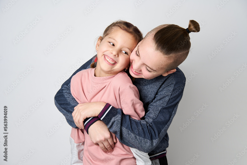 Boy and girl hugging each other on white background Boy and girl hugging each other on white background