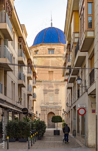 Blue domed basilica between modern apartment blocks. 