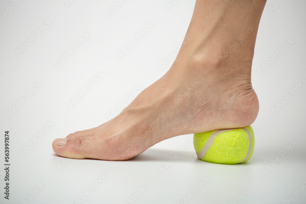 Tennis ball roll massage for plantar fascia stretch. Foot muscle
