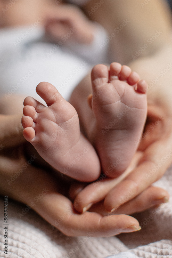 newborn baby feet on mom and dad hands. happy family concept newborn baby feet on mom and dad hands. happy family concept