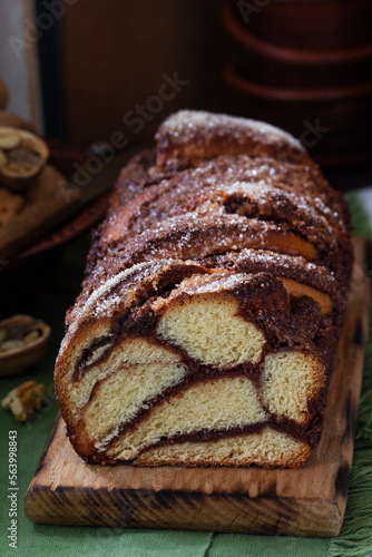 Obraz na płótnie Traditional Easter bread with chocolate and nut filling on a wooden background. w salonie