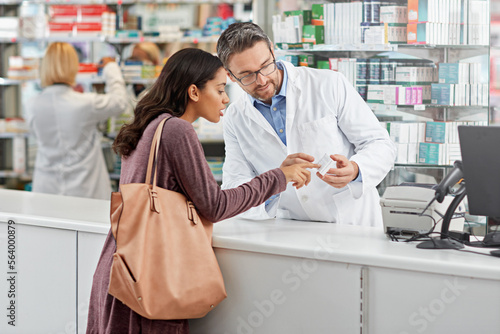 Medicine, help and pharmacist advice with side effects at health store counter for customer service. Pharmaceutical advice and opinion of worker helping girl with medication information at pharmacy.