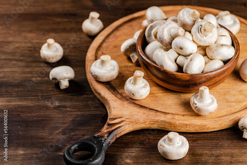 Mushrooms in a bowl on a cutting board. 