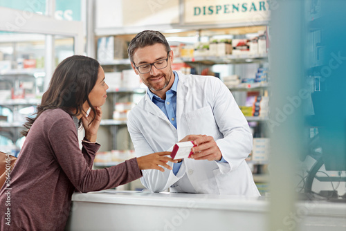 Happy, healthcare and communication of pharmacist with customer at counter for professional expertise. Advice, explanation and opinion of worker helping girl with medicine information at pharmacy.